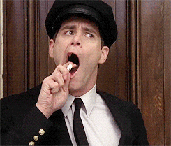 Movie gif. Jim Carrey as Lloyd Christmas in Dumber and Dumber opens his mouth to the side and holds a mouth spray, meant to freshen up his breath, up to his mouth. He spritzes it, but the nozzle is turned unknowingly to the side and spritzes out into the air.