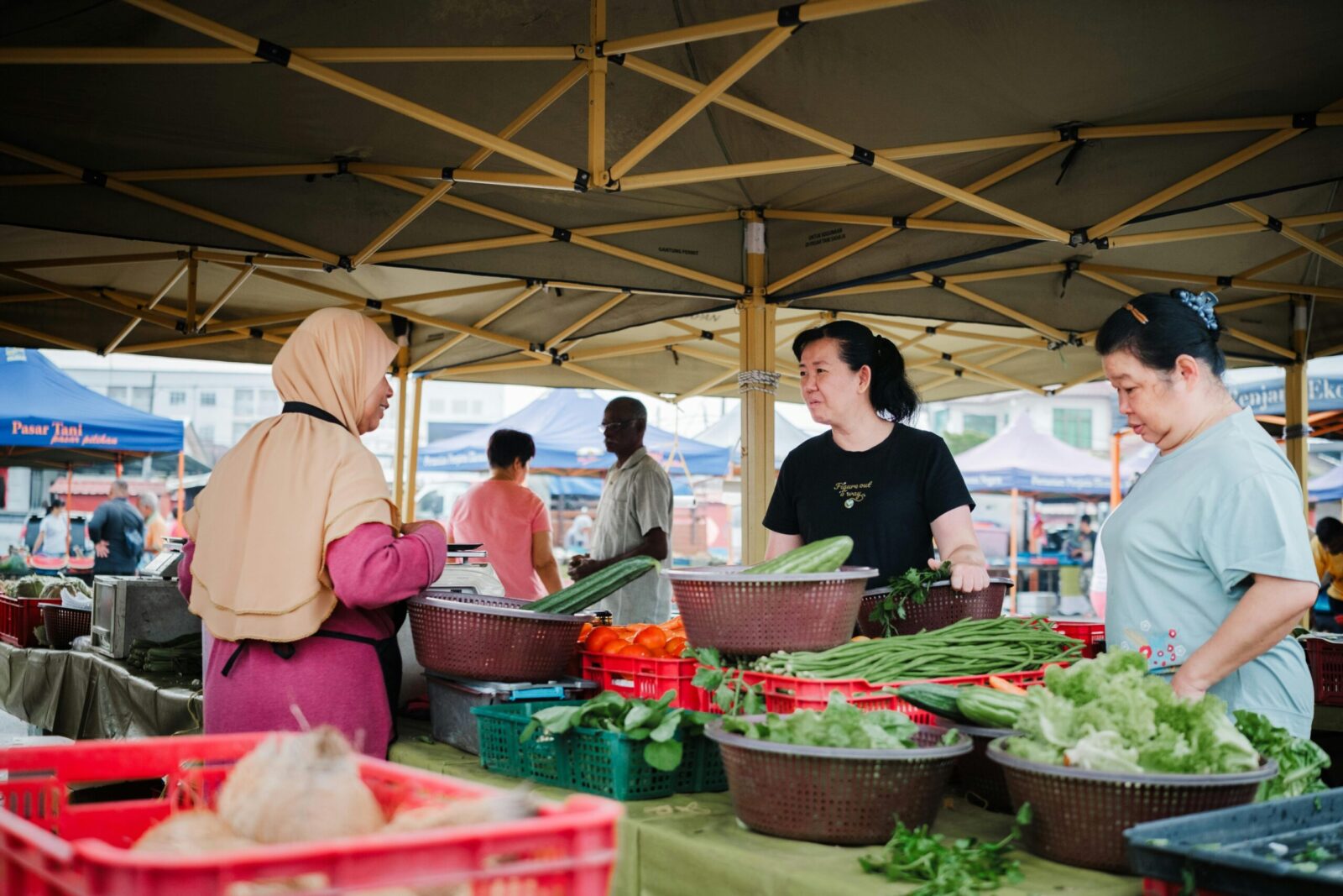 Local vendors and customers interact at Labis morning market, Johor, Malaysia.