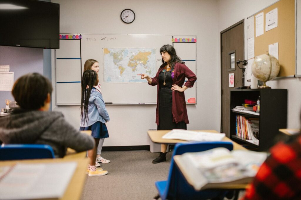 A teacher engaging with students during a classroom session, enhancing learning and participation.