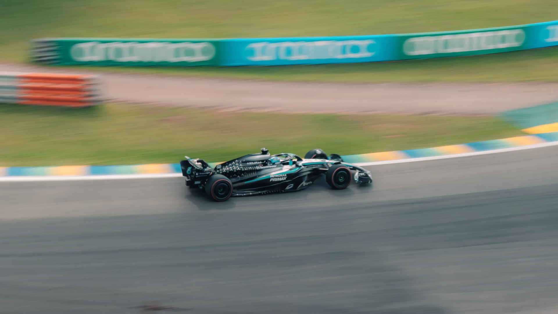 A race car spearing down a track in São Paulo, Brazil, showcasing speed and motion.