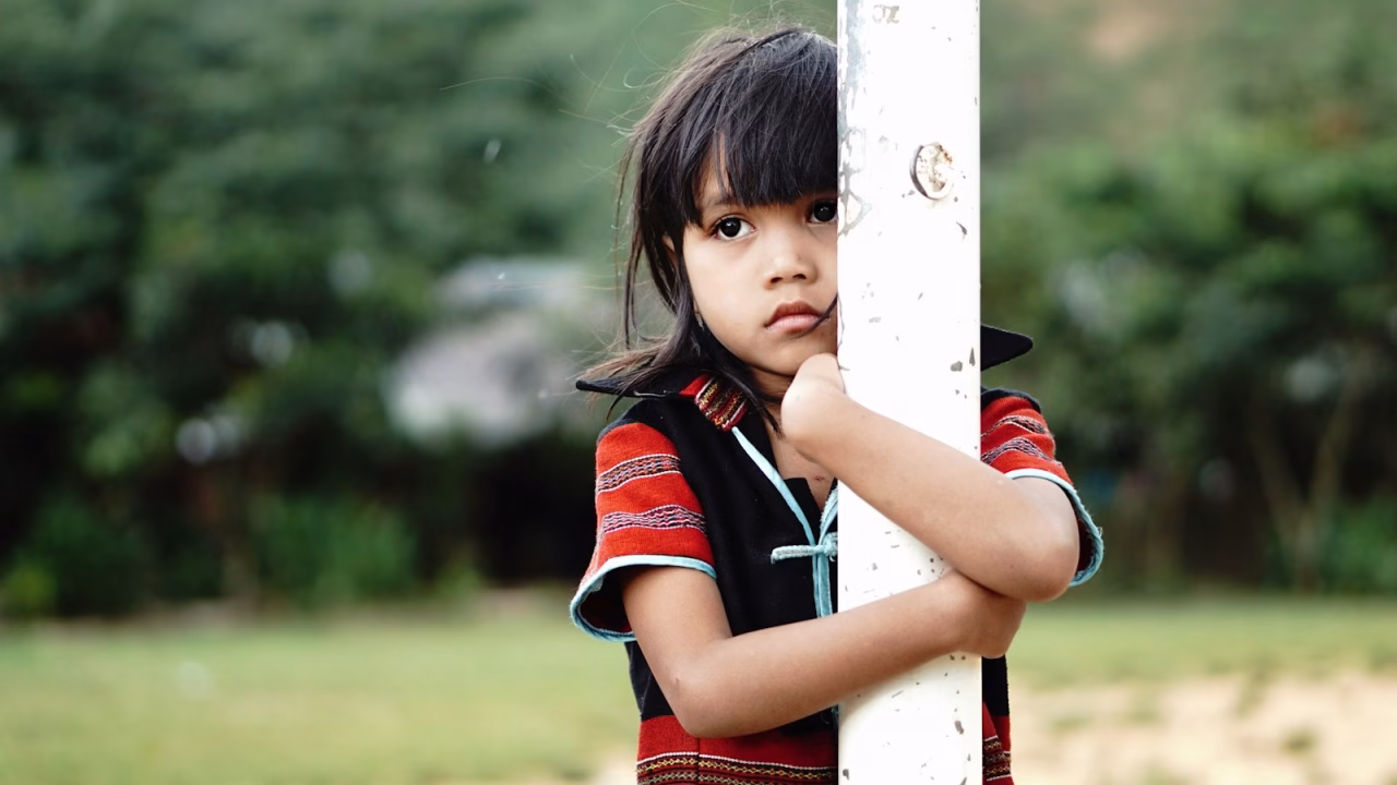 girl hugging white metal post